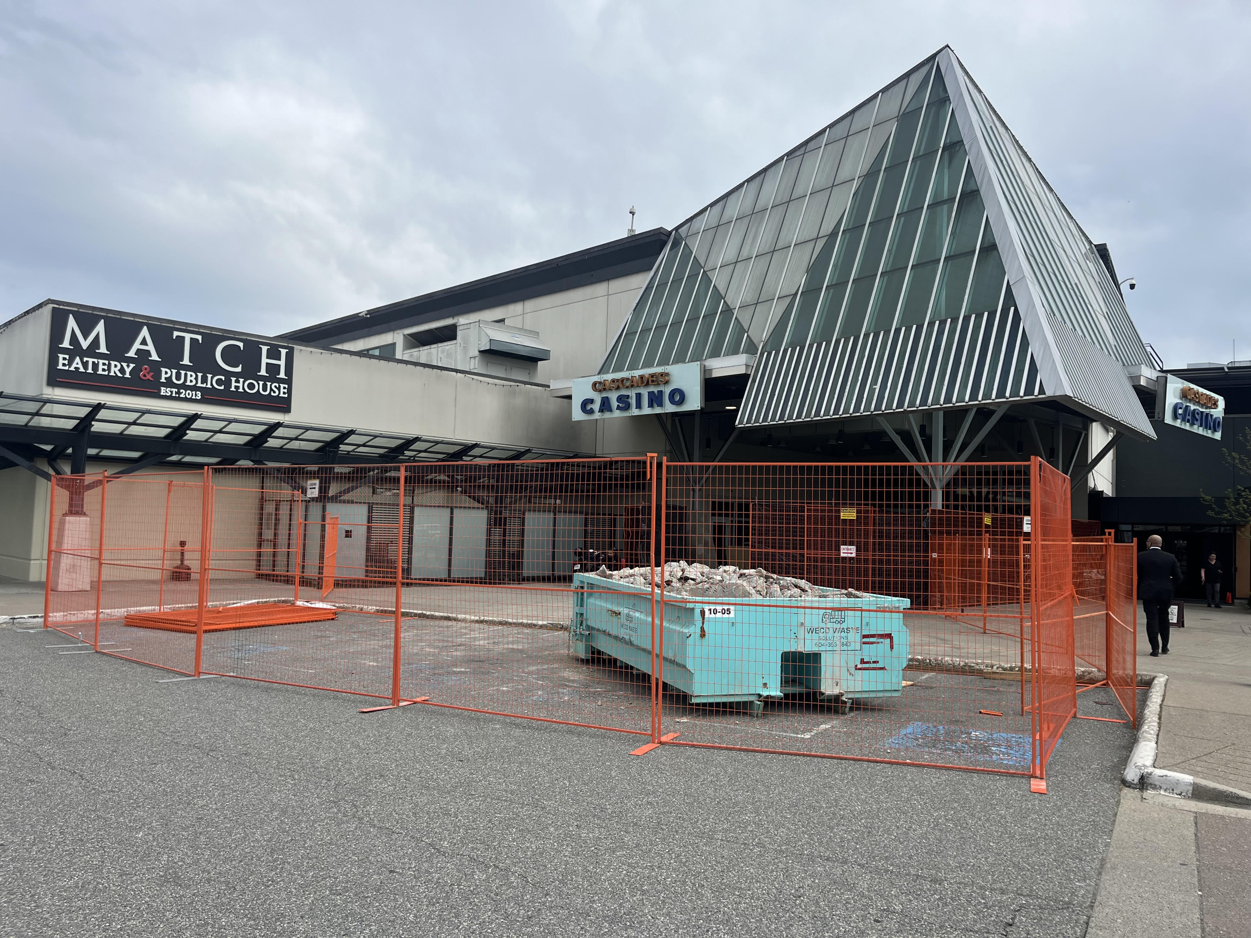Fenced-off work zone and disposal bin at the Cascades Casino and Match Eatery entrance, Langley