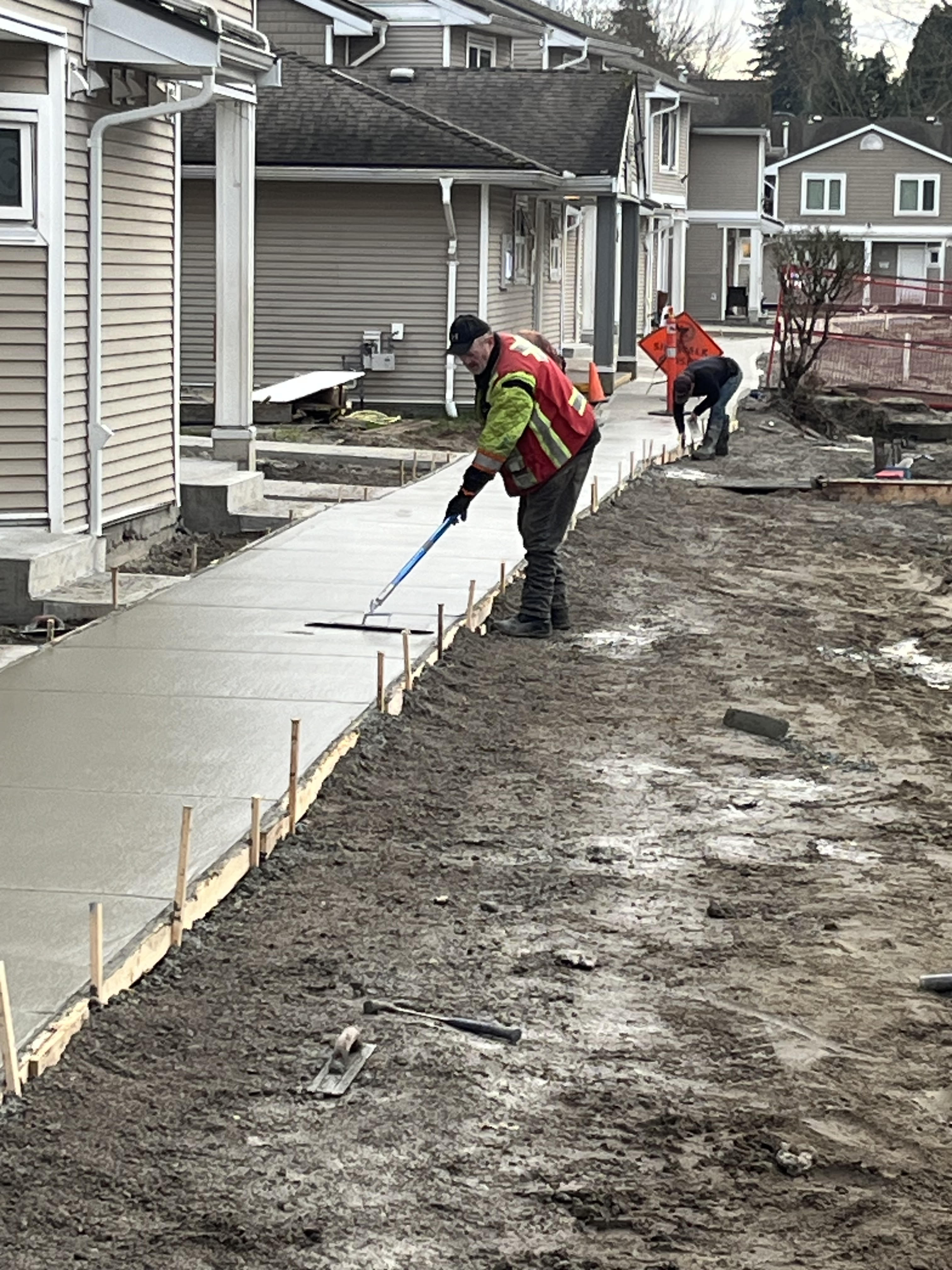 S&K Concrete crew finishing a fresh concrete pour at a multi-family project