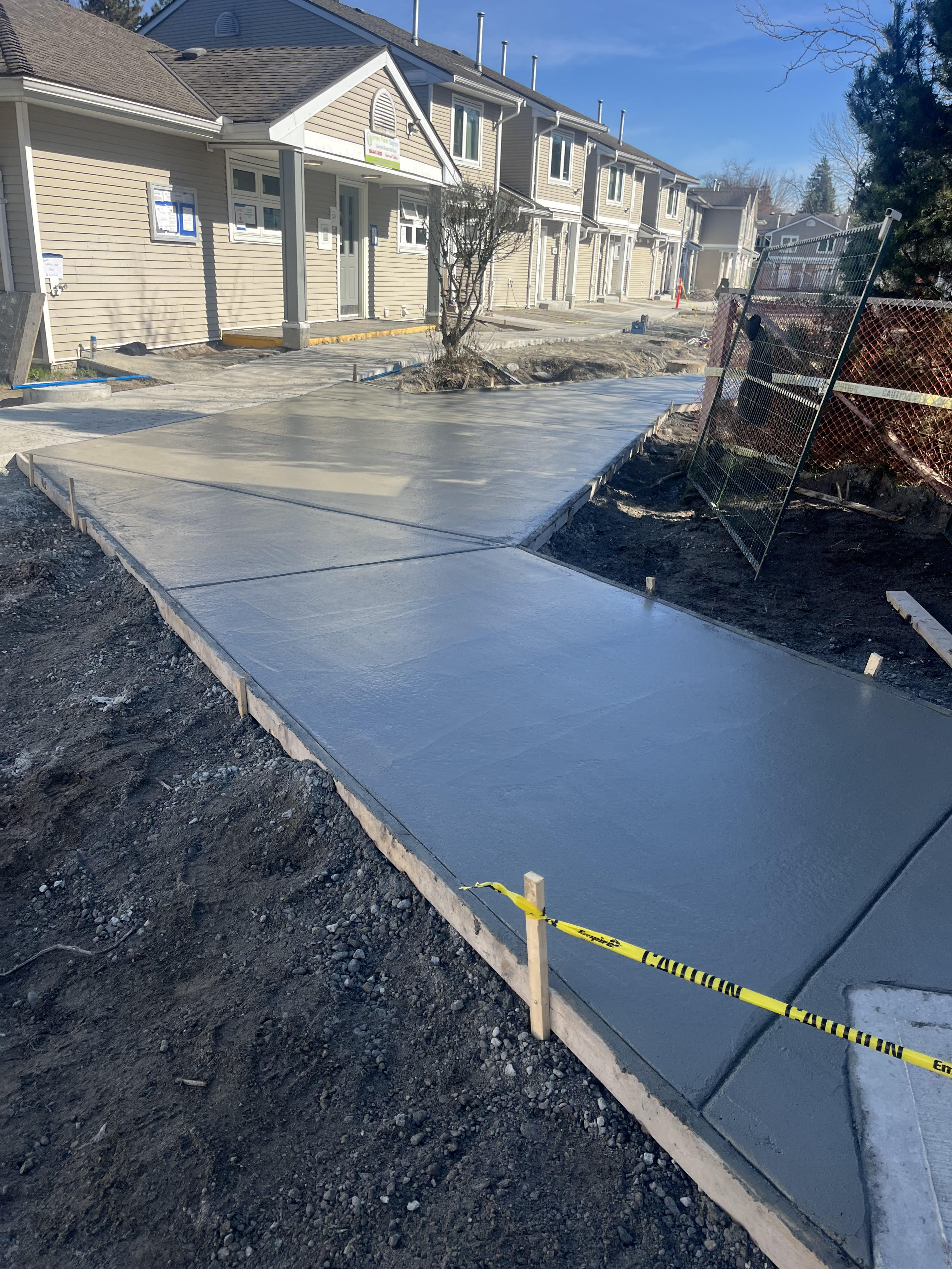 Freshly poured concrete walkway between townhomes